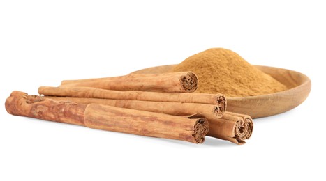 Photo of Dry aromatic cinnamon sticks and powder isolated on white