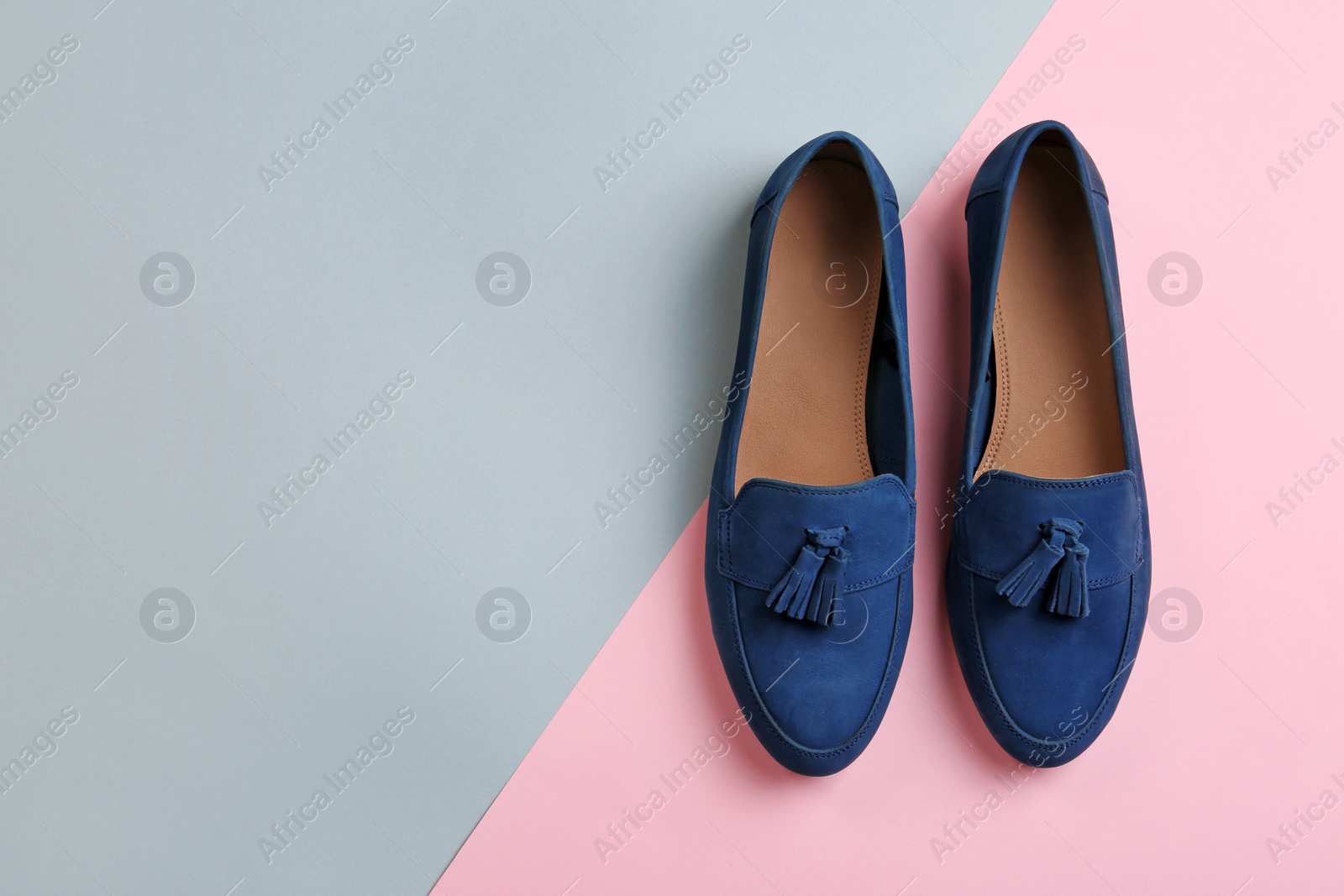 Photo of Pair of female shoes on color background, top view