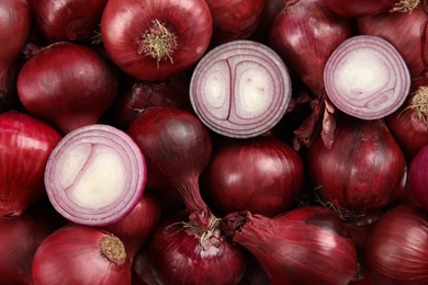 Ripe red onions as background