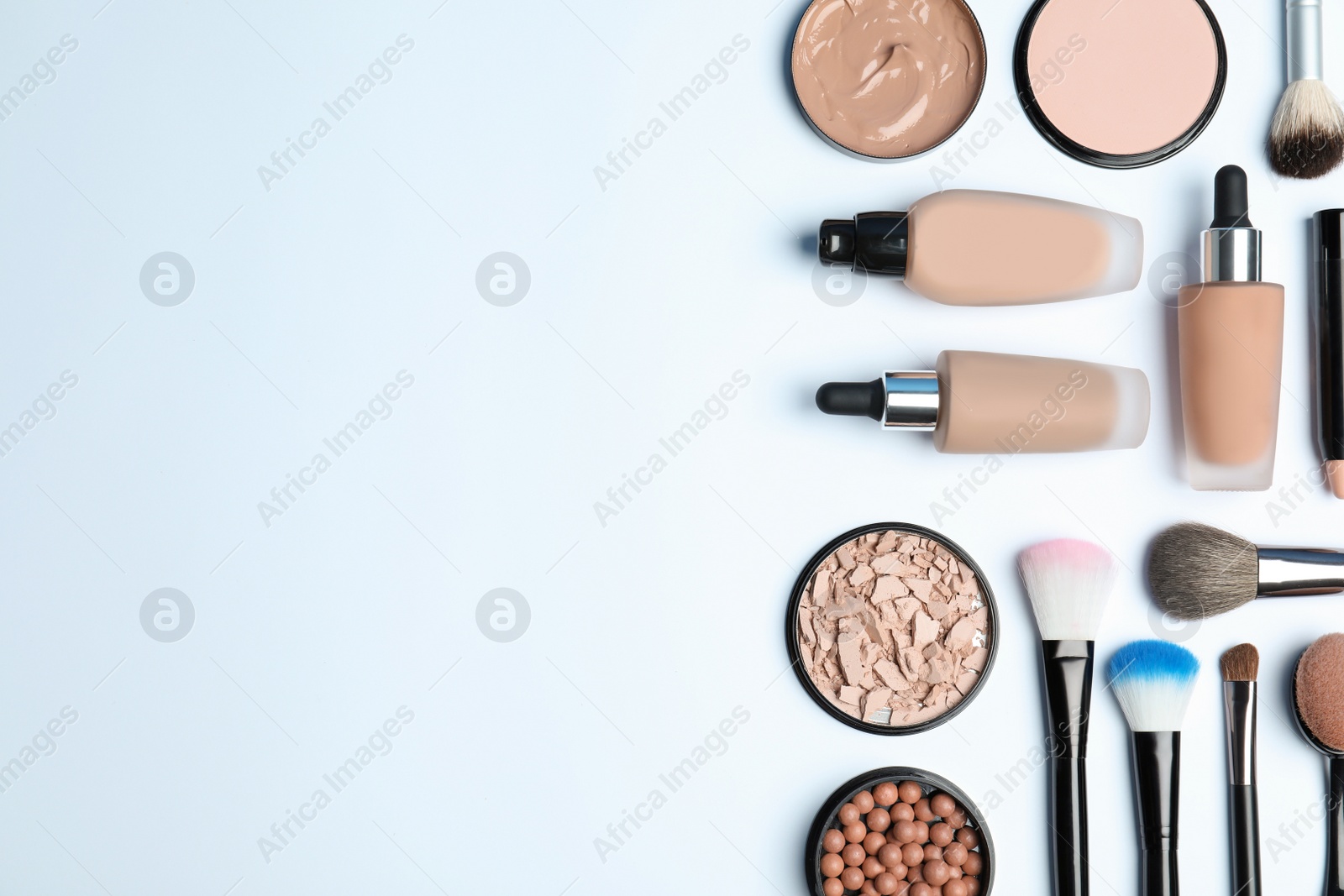 Photo of Flat lay composition with skin foundation, powder and beauty accessories on white background. Space for text