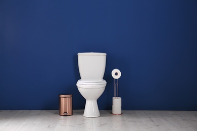 Photo of Simple bathroom interior with new toilet bowl near color wall