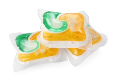 Photo of Many dishwasher detergent pods on white background