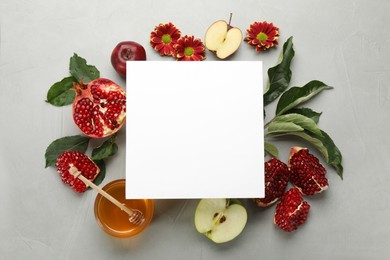 Photo of Flat lay composition with Rosh Hashanah holiday attributes and card on light grey background. Space for text
