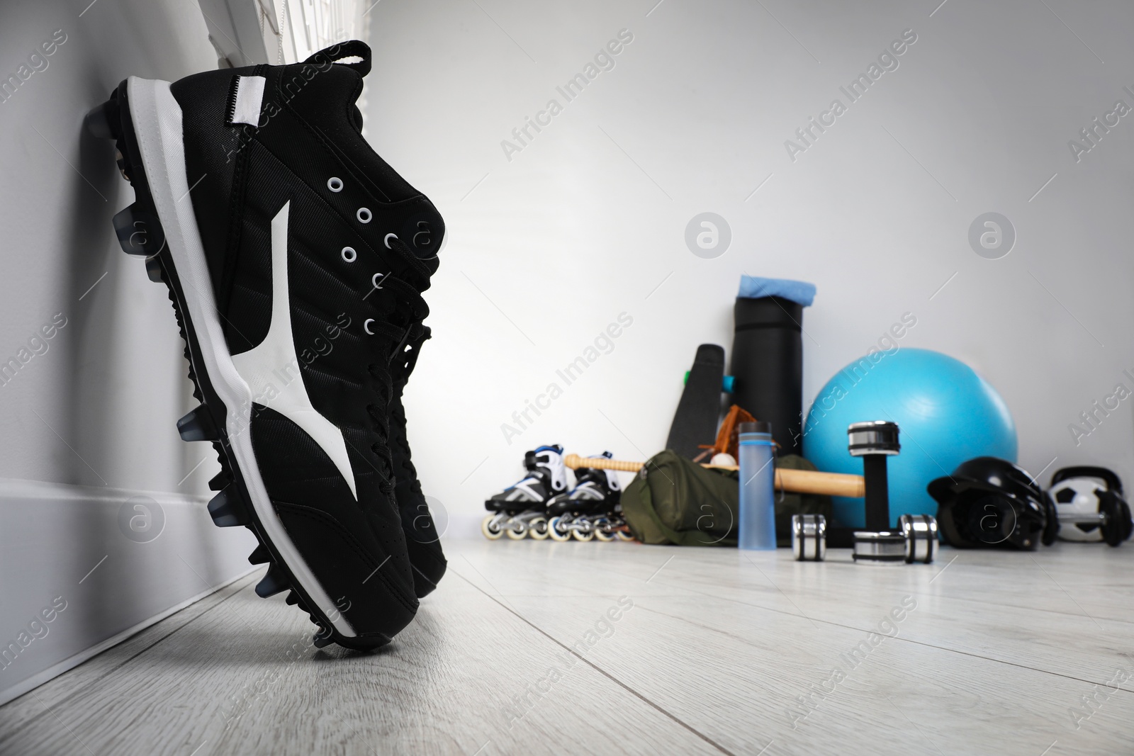 Photo of Black snickers and different sports equipment indoors