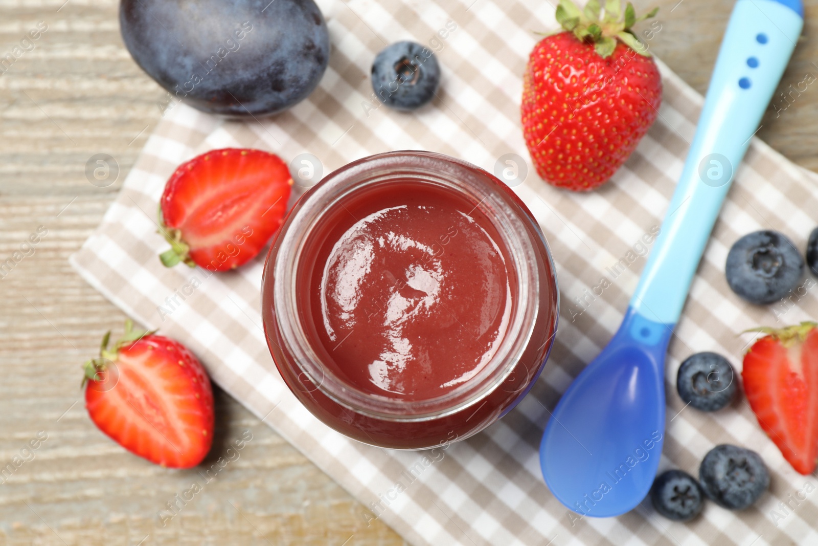 Photo of Healthy baby food and ingredients on wooden table, flat lay