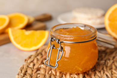 Homemade delicious orange jam on rattan mat