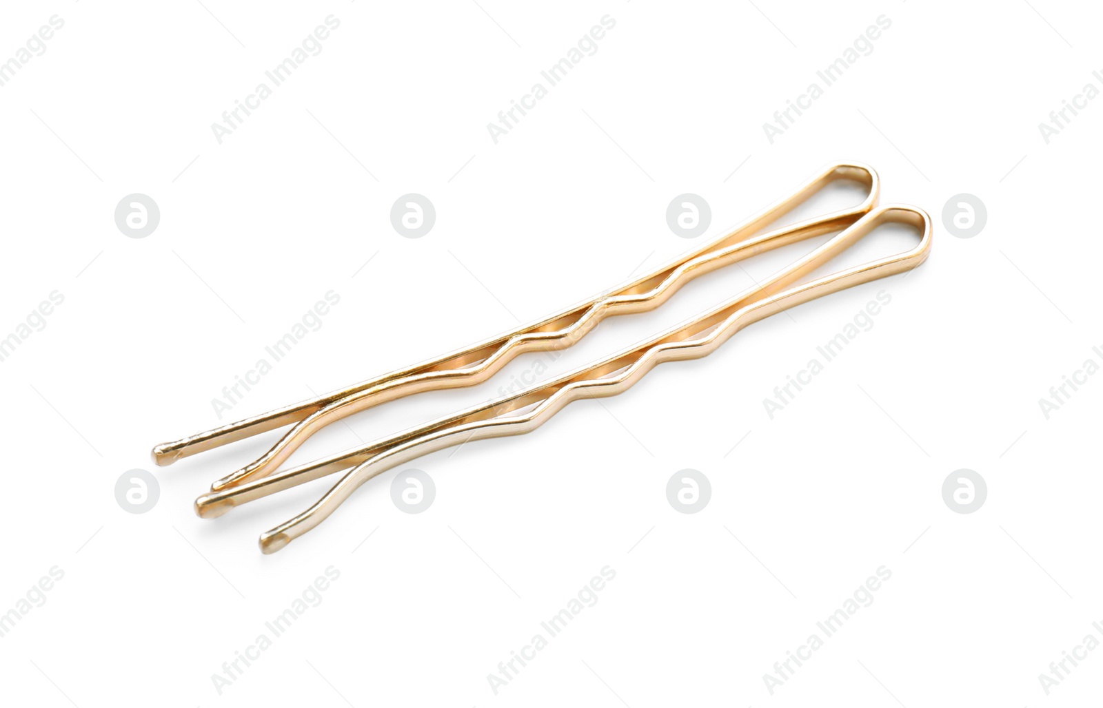 Photo of Two gold hair pins on white background