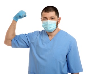 Photo of Doctor with protective mask showing muscles on white background. Strong immunity concept