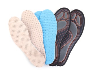 Photo of Pairs of different insoles on white background, top view