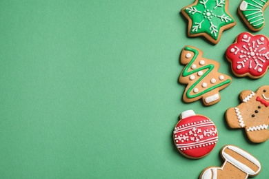 Photo of Flat lay composition with tasty homemade Christmas cookies on green background, space for text