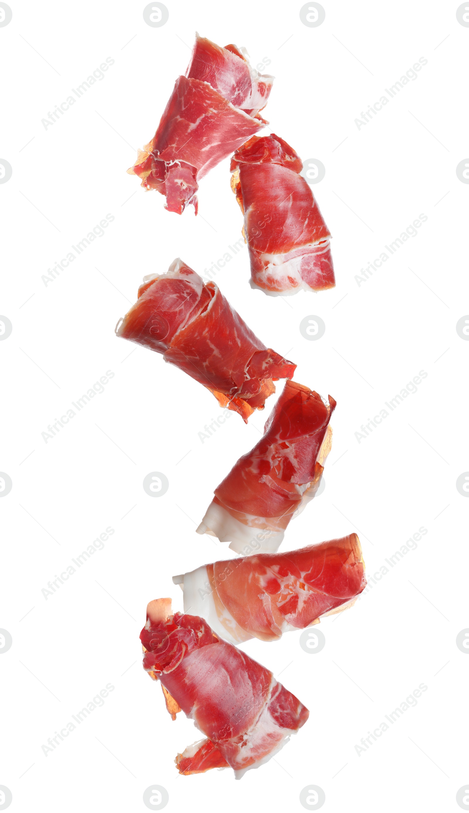 Image of Falling delicious sliced jamon on white background