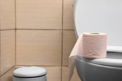 Photo of Soft tissue paper on toilet seat in bathroom. Space for text