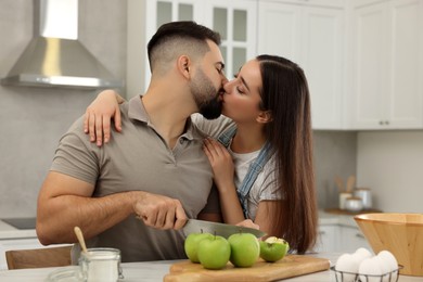 Happy young couple spending time together in kitchen