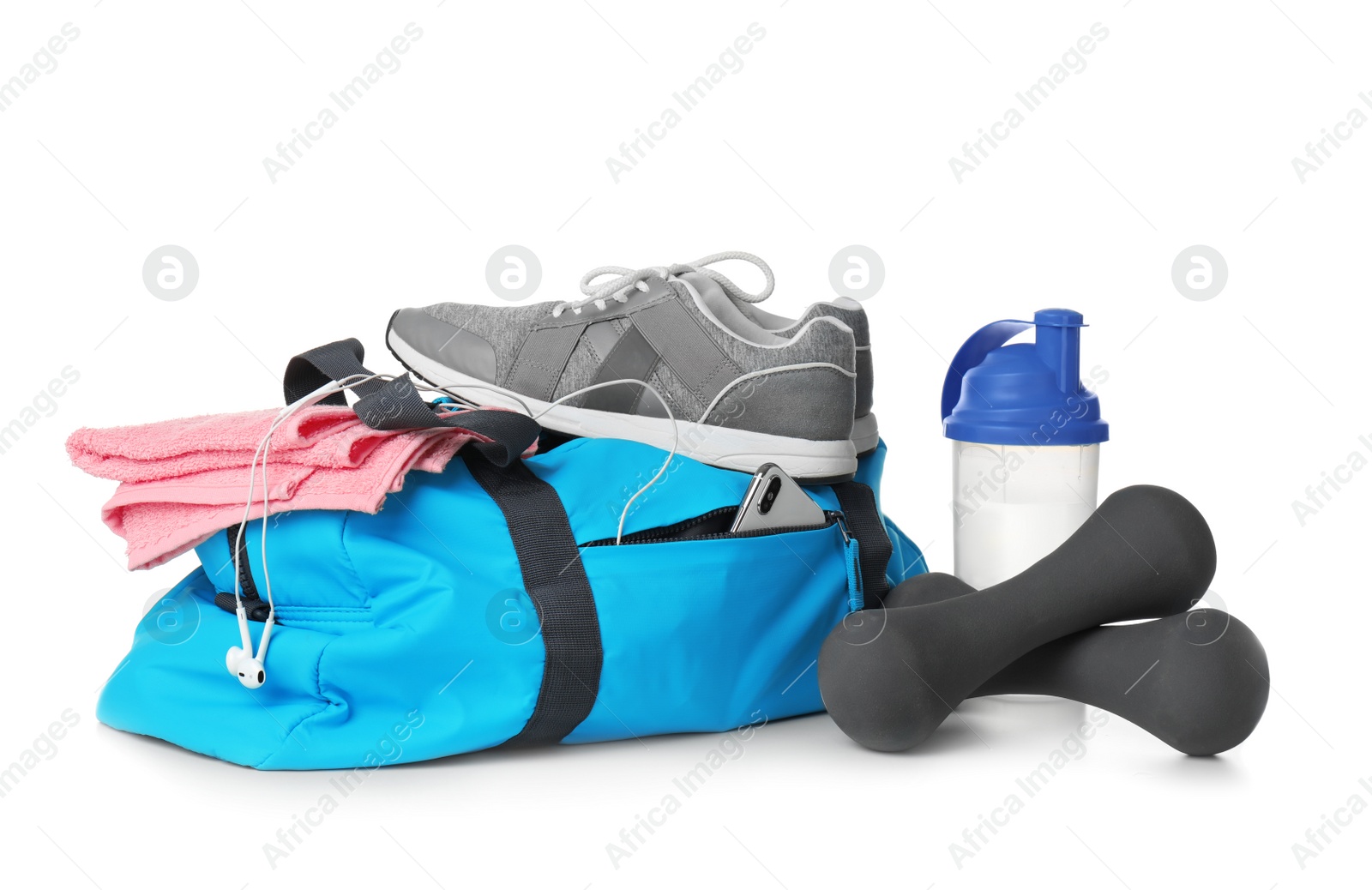 Photo of Sports bag and gym equipment on white background