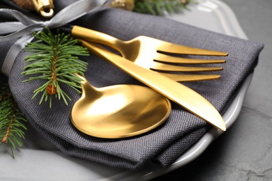 Photo of Festive table setting with beautiful dishware and Christmas decor on black background, closeup