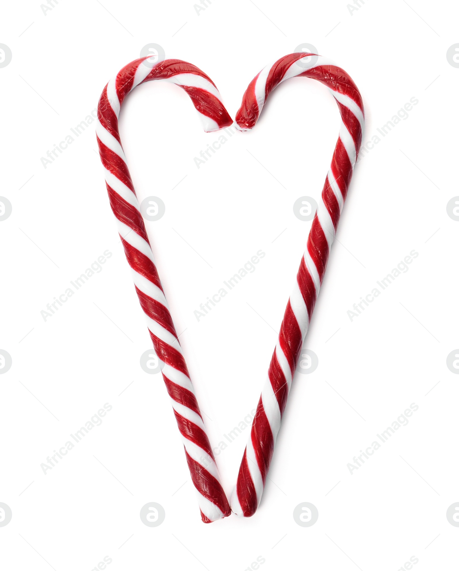 Photo of Heart made of Christmas candy canes on white background, top view