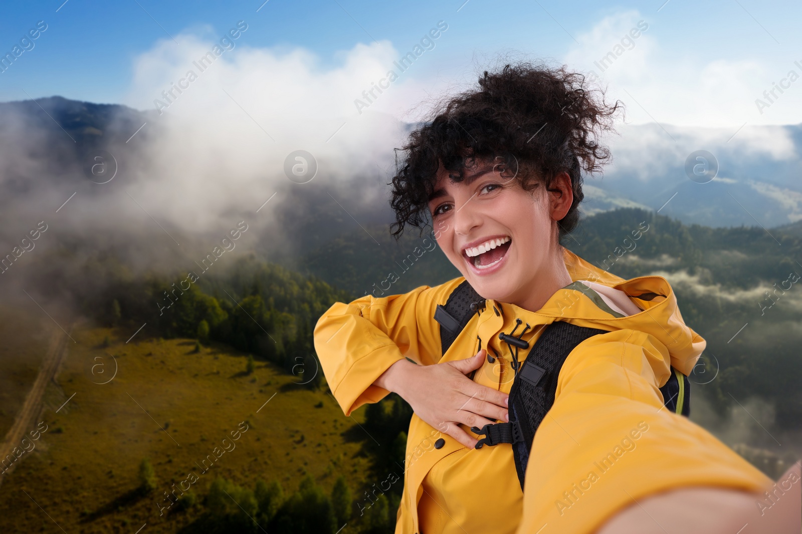 Image of Beautiful woman taking selfie in misty mountains