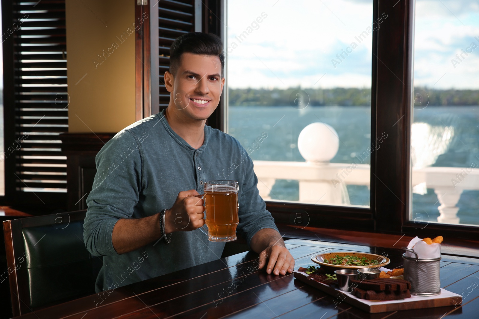 Photo of Man with glass of tasty beer in pub