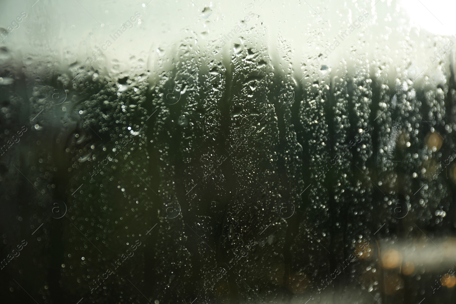 Photo of Blurred view from window on rainy day