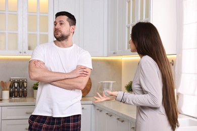 Photo of Emotional couple arguing in kitchen. Relationship problems