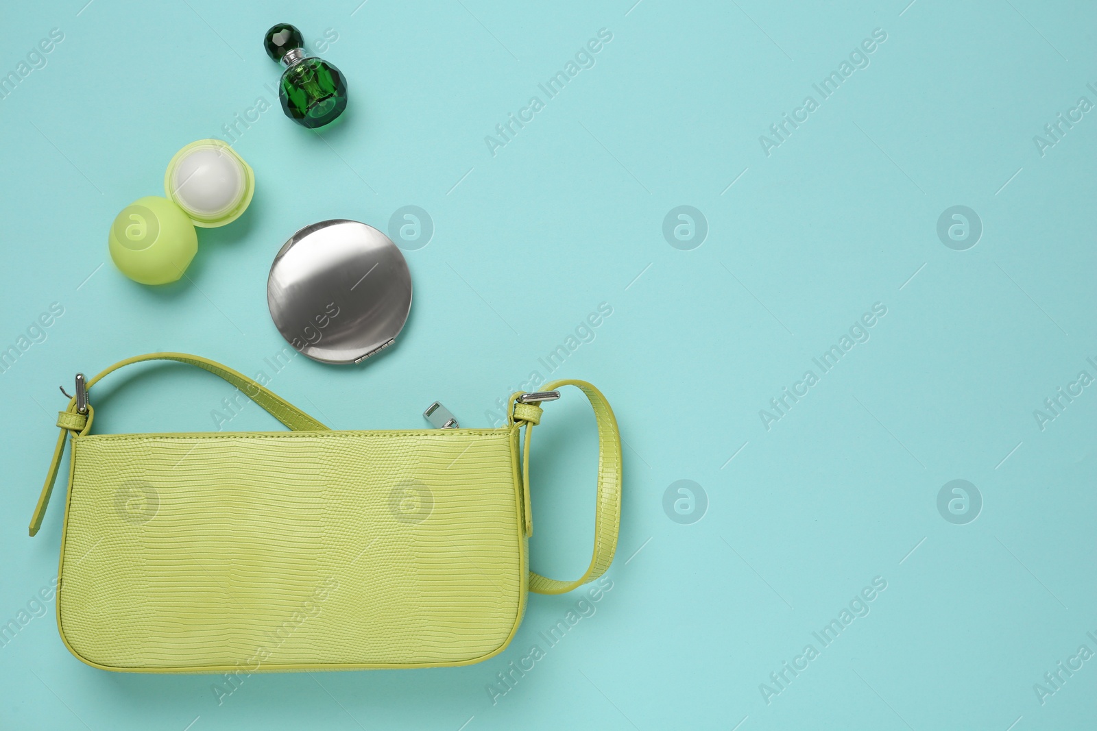 Photo of Flat lay composition with stylish baguette handbag on light blue background. Space for text