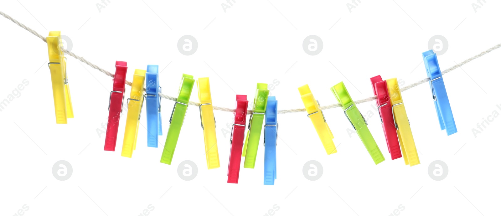 Photo of Colorful plastic clothespins hanging on rope against white background