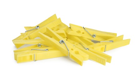 Photo of Bright yellow plastic clothespins on white background