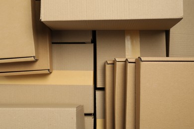 Many cardboard boxes as background, top view. Packaging goods