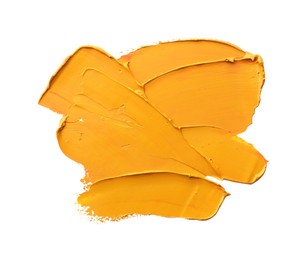 Photo of Orange oil paint stroke on white background, top view