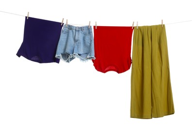 Photo of Different clothes drying on laundry line against white background