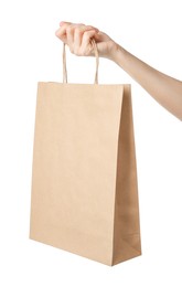 Photo of Woman holding kraft paper bag on white background, closeup. Mockup for design