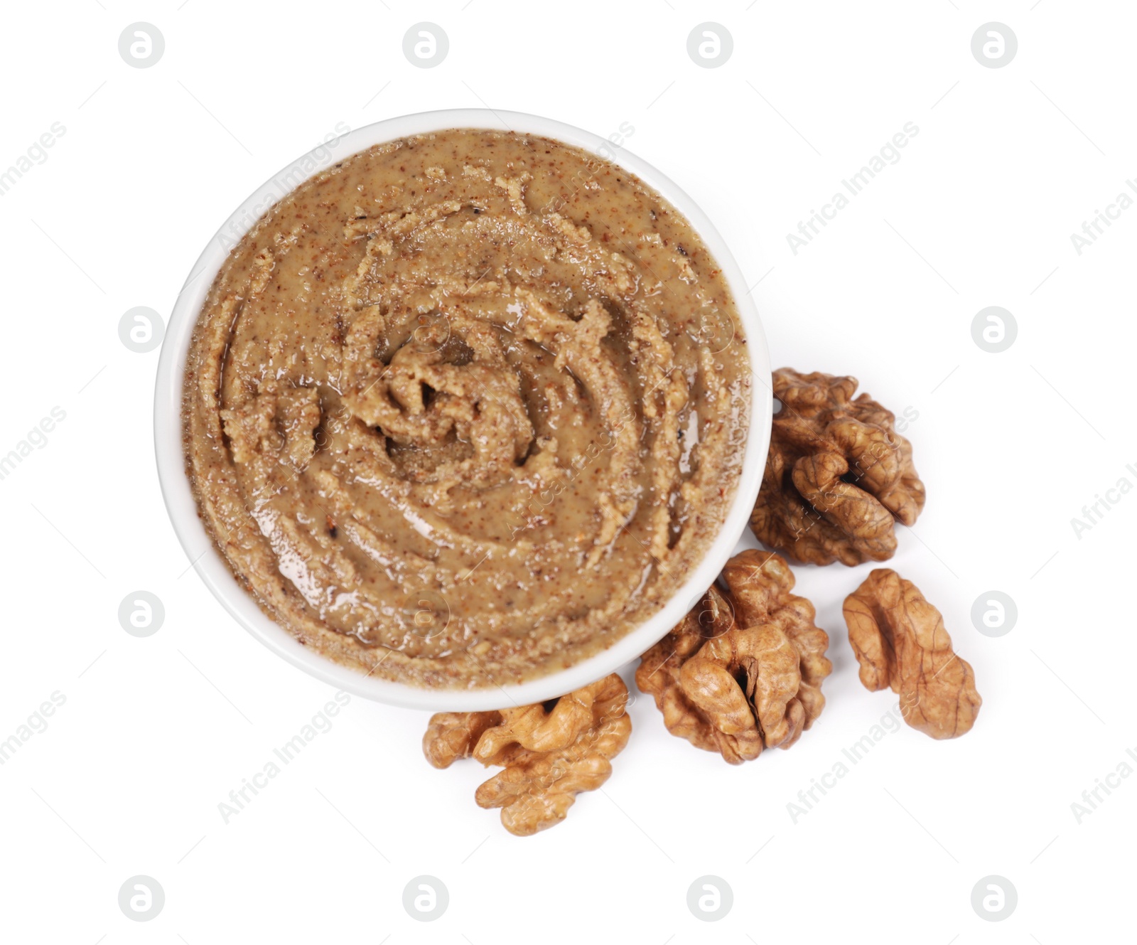 Photo of Delicious nut butter and walnuts isolated on white, top view