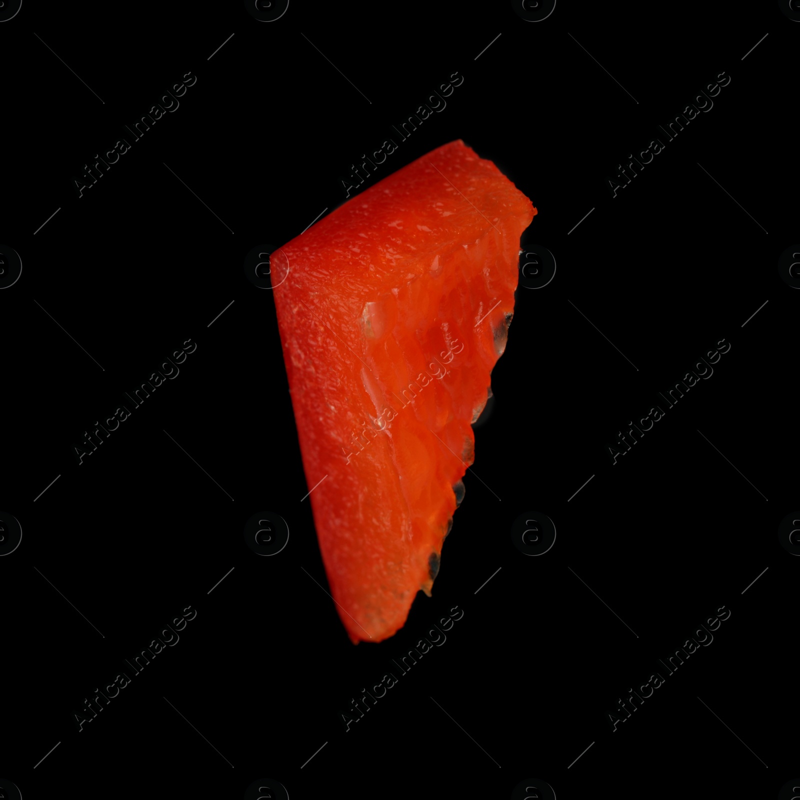 Photo of Piece of red bell pepper on black background