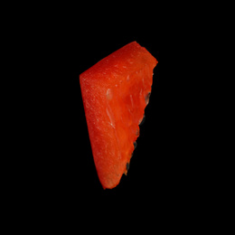 Piece of red bell pepper on black background