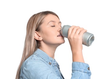 Beautiful woman drinking from beverage can on white background