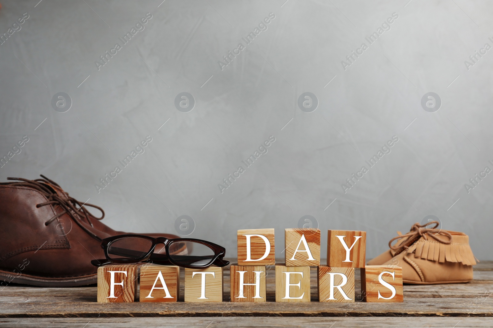 Photo of Shoes and cubes on wooden table. Father's day celebration