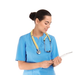 Portrait of young medical assistant with stethoscope and tablet on white background