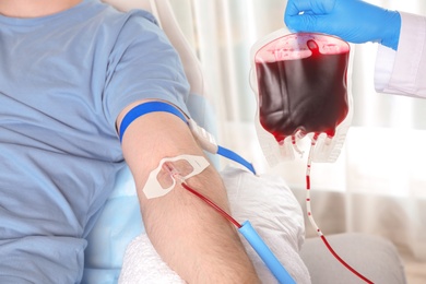 Photo of Man donating blood to save someone's life in hospital