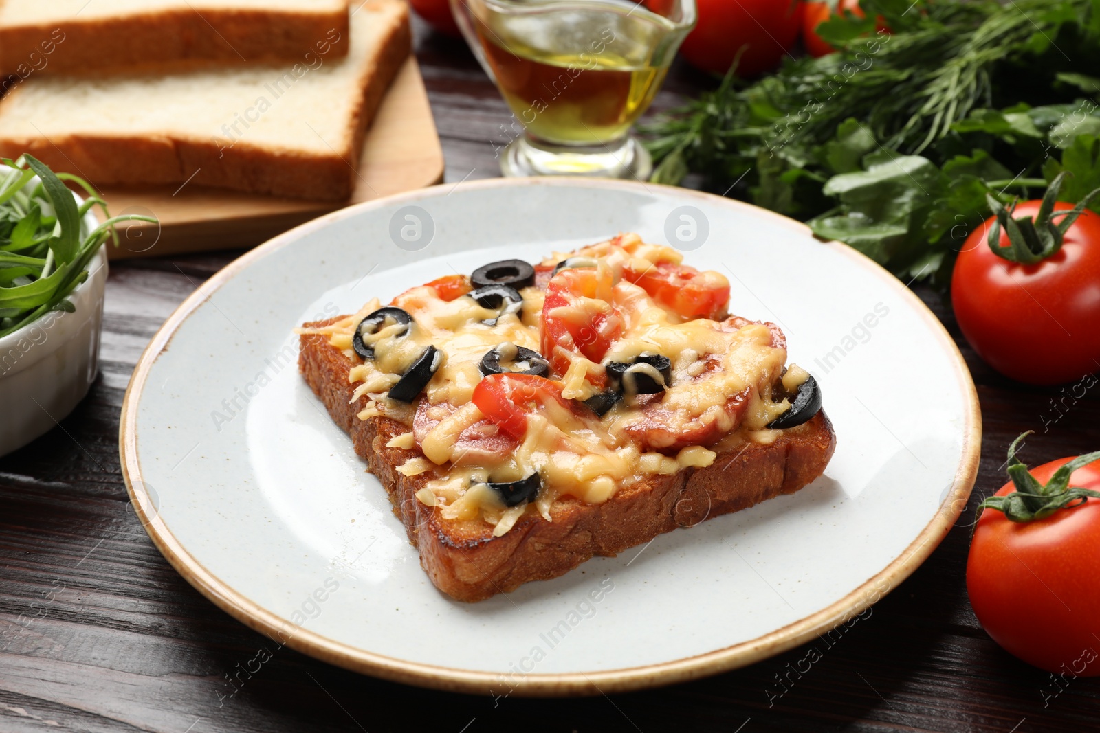 Photo of Tasty pizza toast and products on wooden table