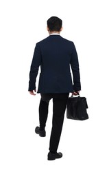 Photo of Businessman in suit with briefcase walking on white background, back view