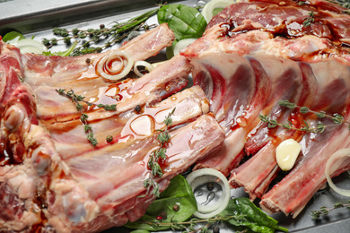 Photo of Raw spare ribs with herbs and seasonings, closeup