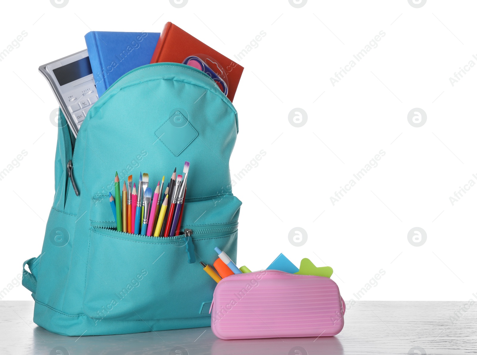 Photo of Modern backpack with stationery on white background