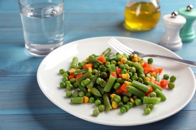 Mix of fresh vegetables served on light blue wooden table