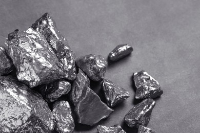 Photo of Pile of silver nuggets on grey table, closeup