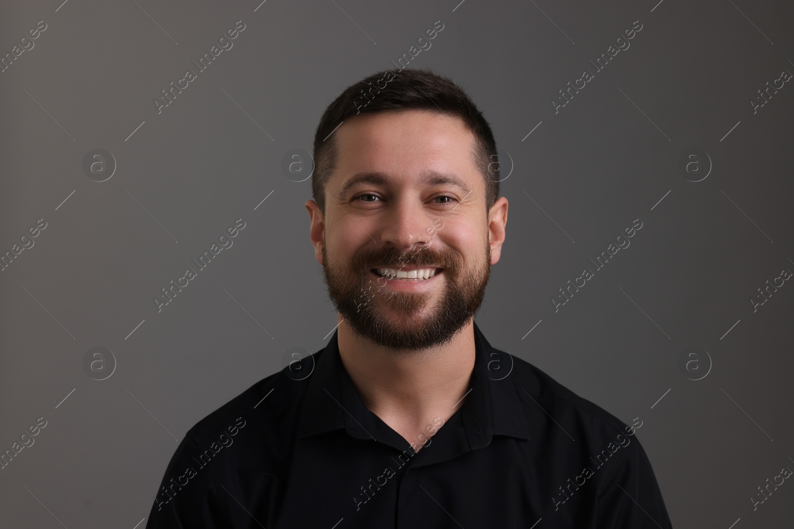 Photo of Personality concept. Happy man on grey background