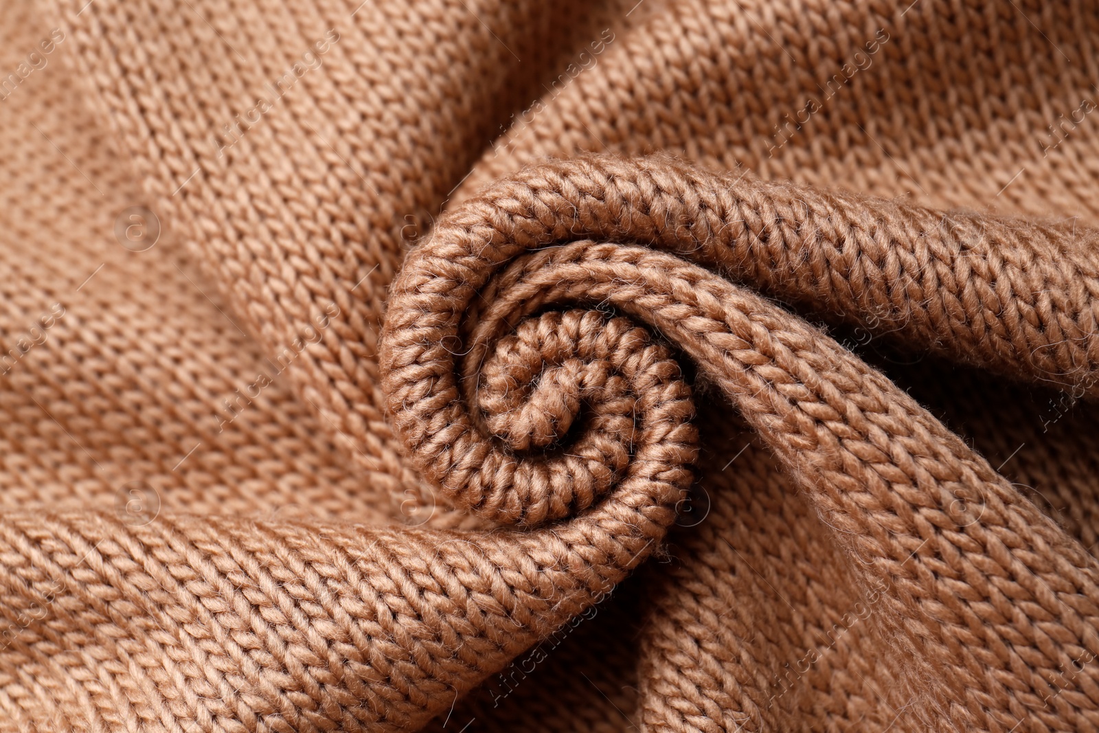 Photo of Brown knitted fabric as background, top view