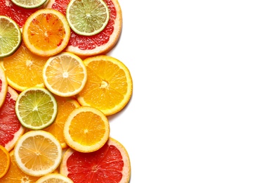 Slices of fresh citrus fruits on white background, top view