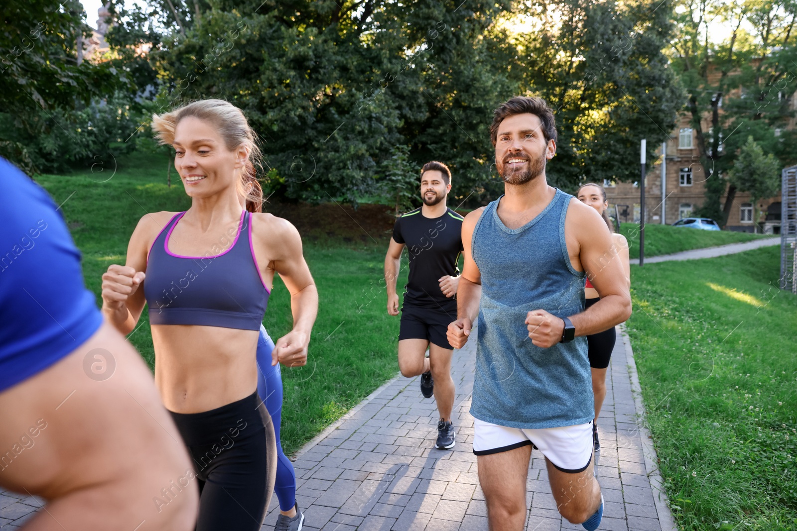 Photo of Group of people running in park. Active lifestyle