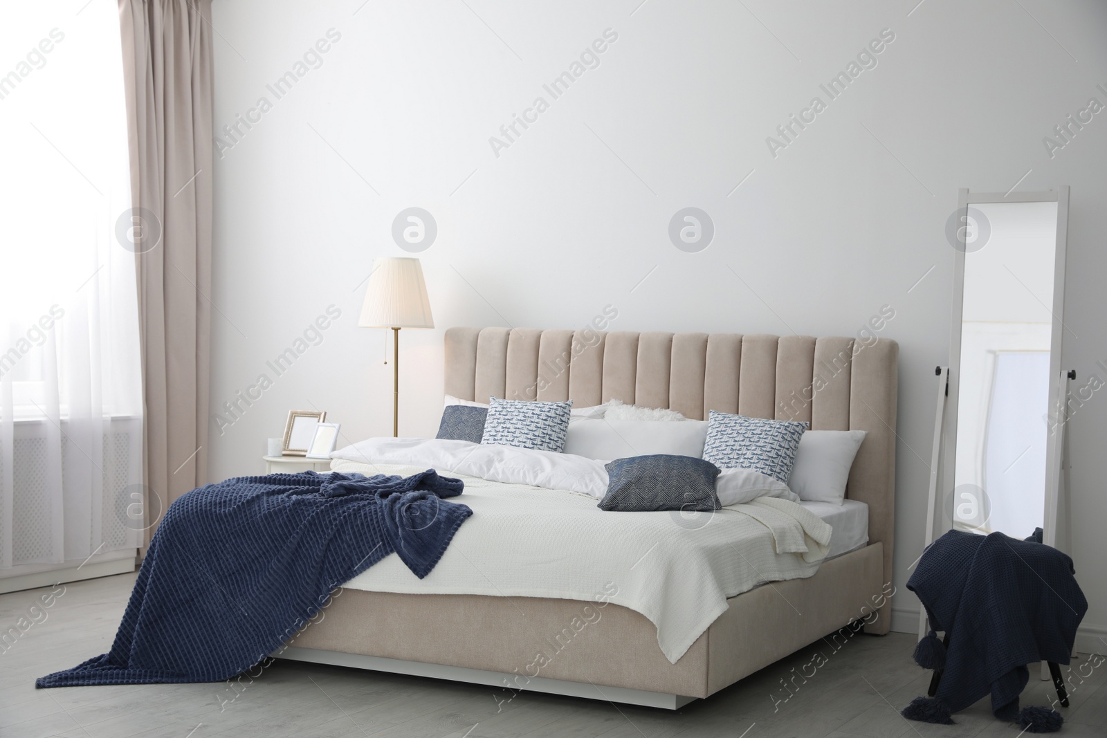 Photo of Comfortable bed with pillows in room. Stylish interior design