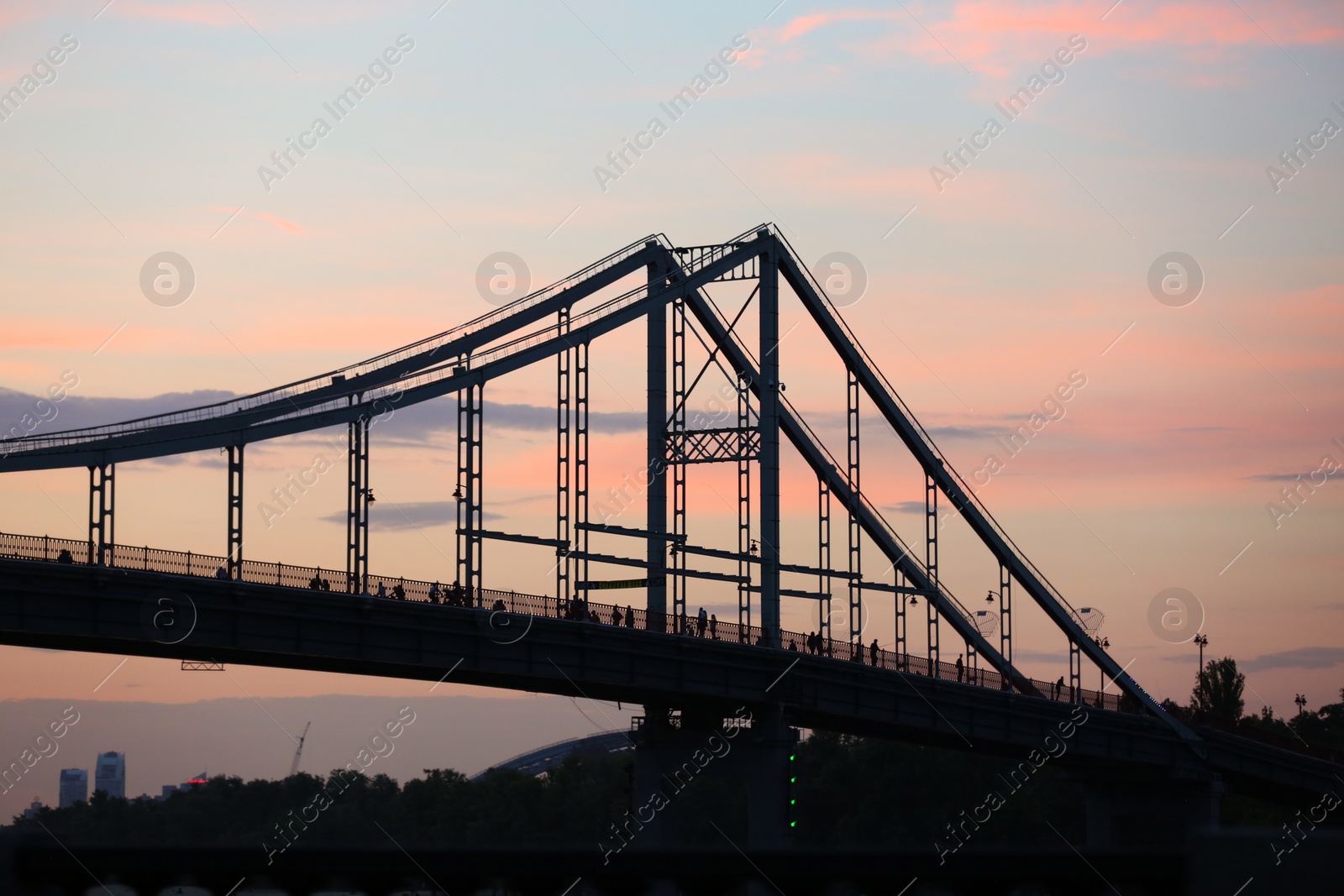 Photo of KYIV, UKRAINE - MAY 23, 2019: Beautiful view of pedestrian bridge over Dnipro river in evening